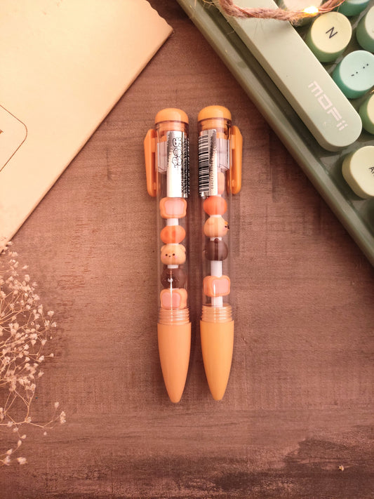 Stylo transparent avec figurines oursons flottantes pour la rentrée des classes.