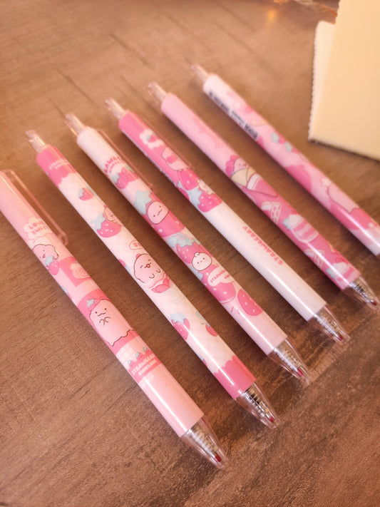 Collection de stylos gel noirs kawaii motifs dinosaure et fraise pour la rentrée des classes.